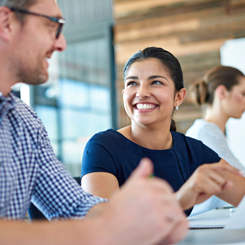 Image of male and female co-workers engaged in conversation