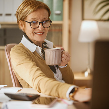 Woman drinking coffee at desk