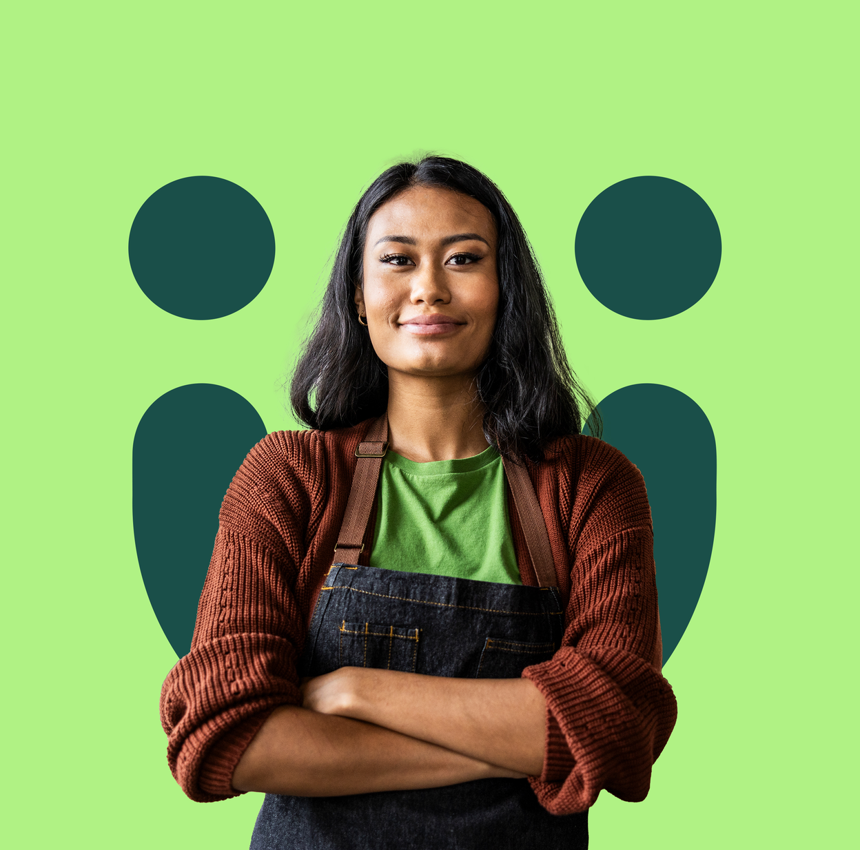 A young woman wearing an apron stands in front of a green background.