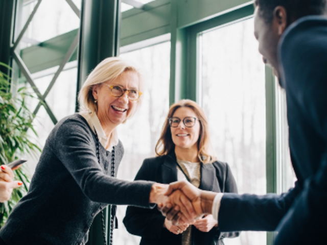 Payroll and workforce management leaders shaking hands